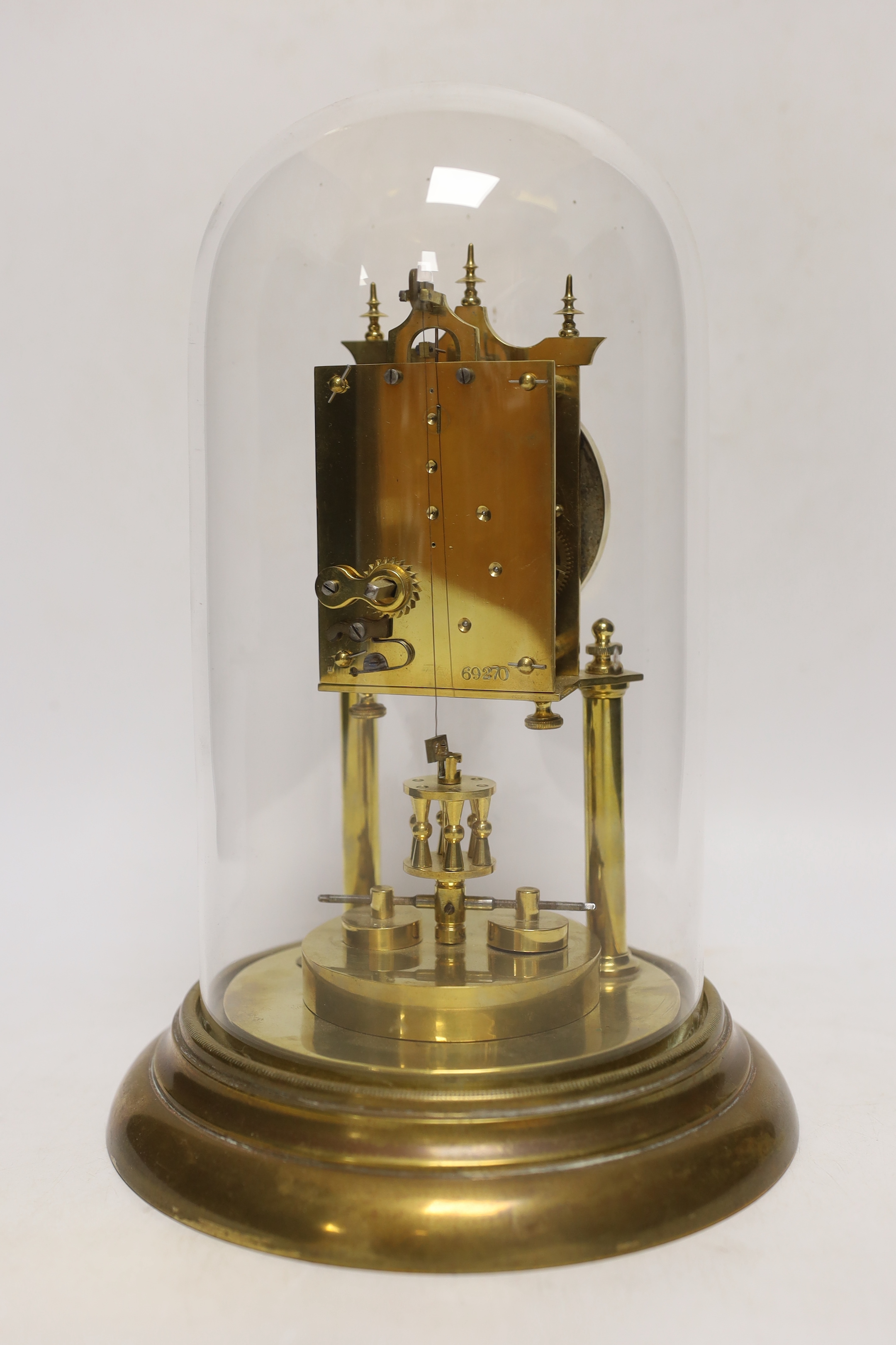An early 20th century clock under a glass dome, 27cm high